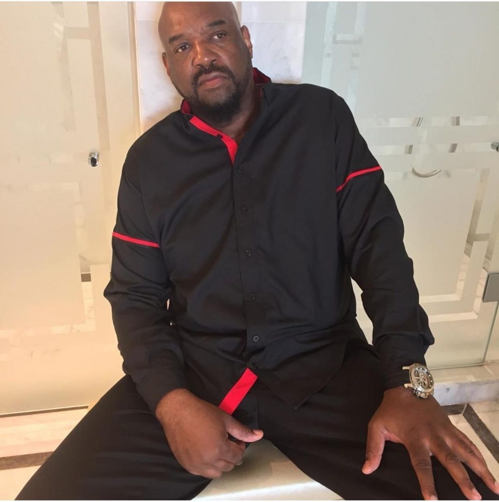 Man in black shirt seated