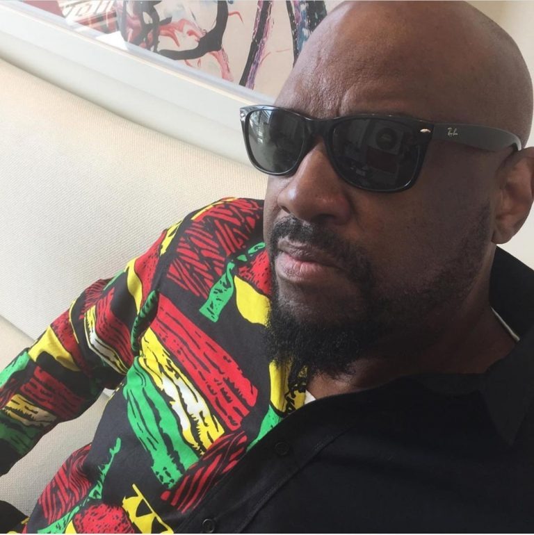 Man with sunglasses and patterned shirt