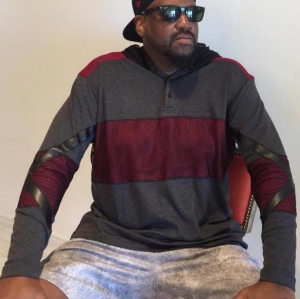 Man in gray and red outfit